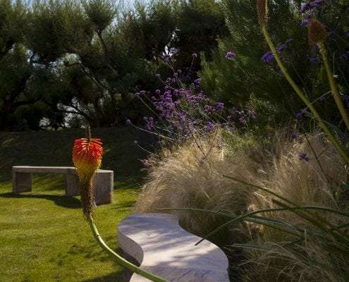 Photo of west sussex contemporary coastal garden design with bespoke sculptural bench